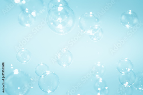 abstract background with soap bubbles floating on blue background.