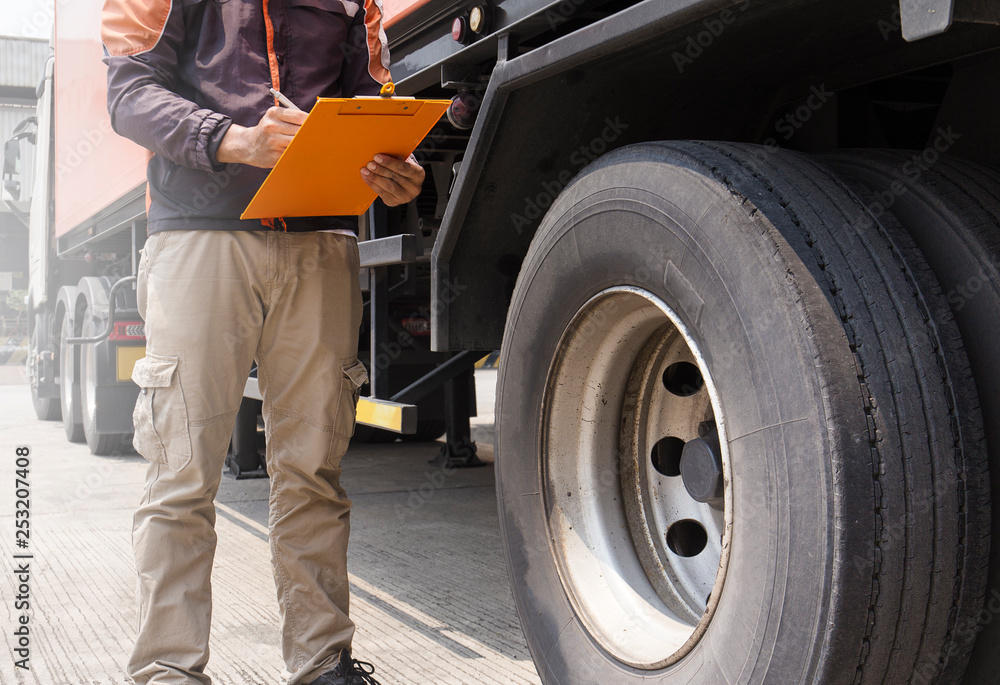 Truck Drivers is Checking the Truck's Safety Maintenance Checklist. Lorry Driver. Inspection Truck Safety of Semi Truck Wheels Tires. Truck Drivers is Checking the Truck's Safety Maintenance Checklist. Lorry Driver. Inspection Truck Safety of Semi Truck Wheels Tires.