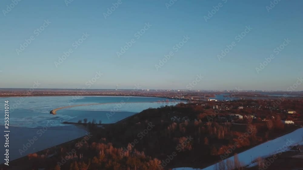 Vyshgorod quay - Kyiv reservoir. Winter aerial shots with deep water color at sunset and beautiful nature Vyshgorod quay - Kyiv reservoir. Winter aerial shots with deep water color at sunset and beautiful nature
