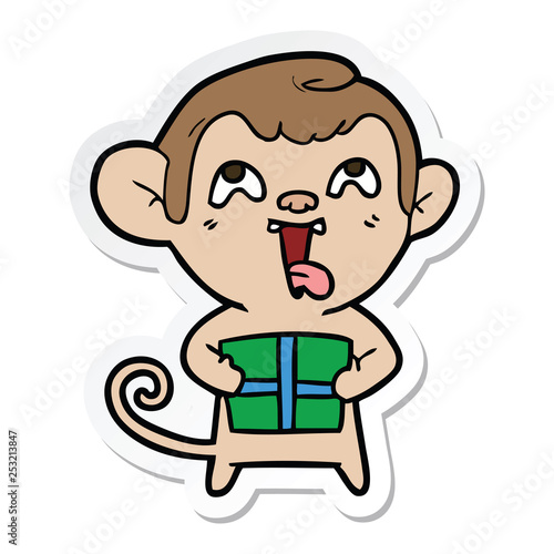 sticker of a crazy cartoon monkey with christmas present