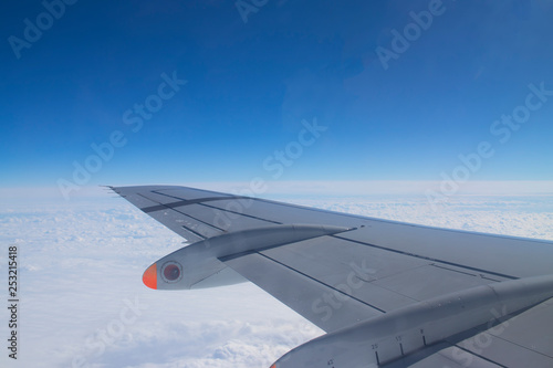 view from the eluminator on the wing of the aircraft against the sky. Concept: flight, rest, tourism.
