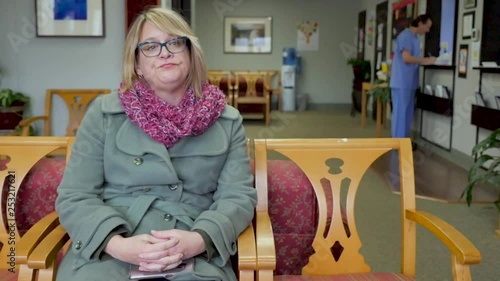 Female patient sitting in a hospital or medical office waiting room