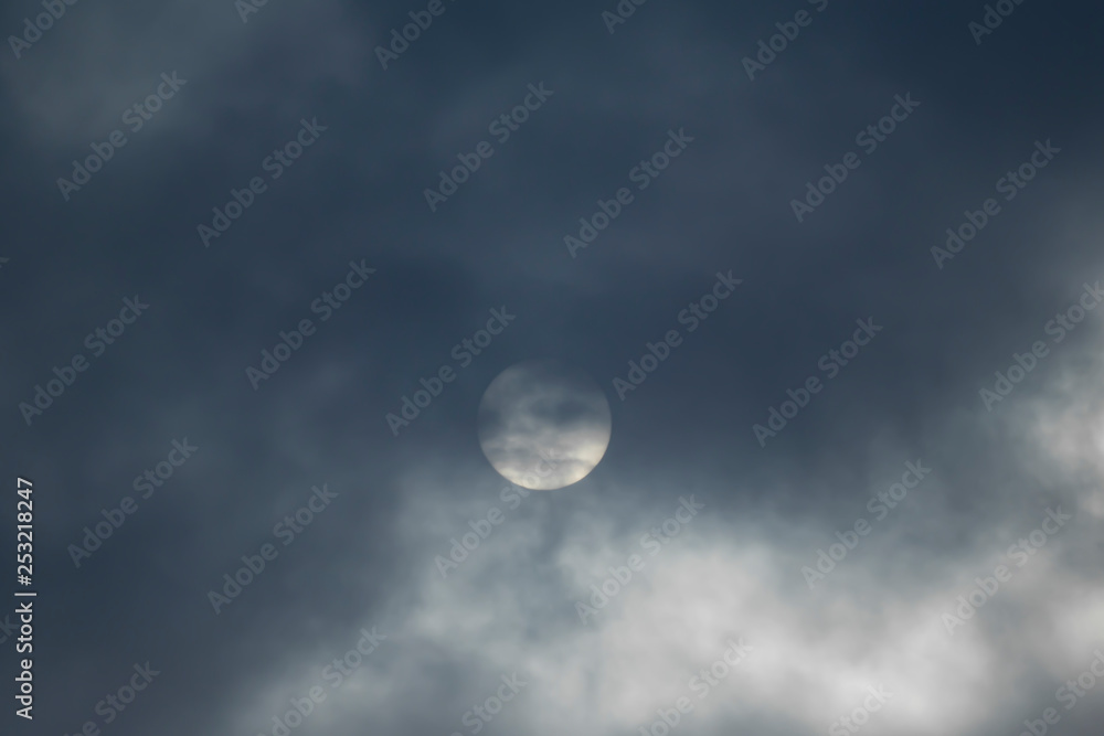 The sun is covered with dark clouds, the sun defocused in the clouds. The sun is covered with dark clouds, the sun defocused in the clouds.