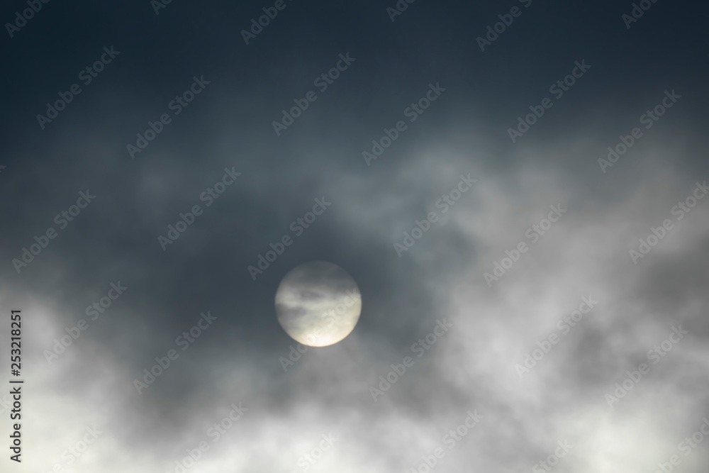The sun is covered with dark clouds, the sun defocused in the clouds. The sun is covered with dark clouds, the sun defocused in the clouds.