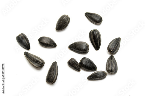 Black sunflower seeds on a white background.