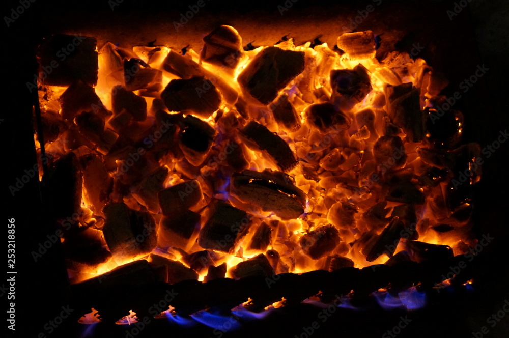 hot wood coals burn with bright flame in iron brazier. hot wood coals burn with bright flame in iron brazier.