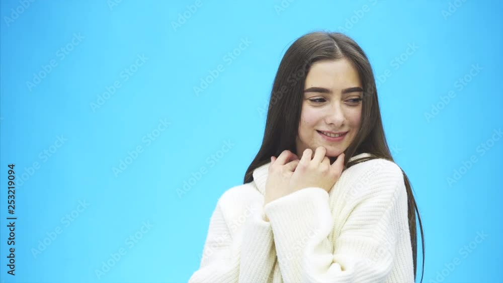 Portrait of cute morning girl. Beautiful cheerful teen girl looking at camera over blue background. Young woman posing in pajamas at studio. Portrait of cute morning girl. Beautiful cheerful teen girl looking at camera over blue background. Young woman posing in pajamas at studio.
