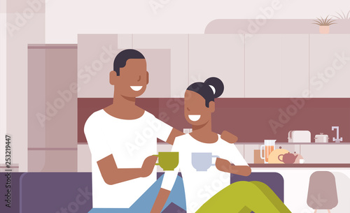 couple drinking tea coffee african american man woman sitting on couch happy lovers communicating modern kitchen interior male female cartoon characters portrait horizontal