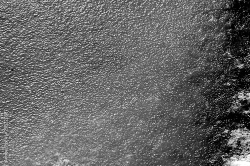 River ice texture background close up. Black and white