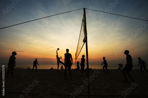 silhouettes of people play Volleyball on sunset background © browneyefoto