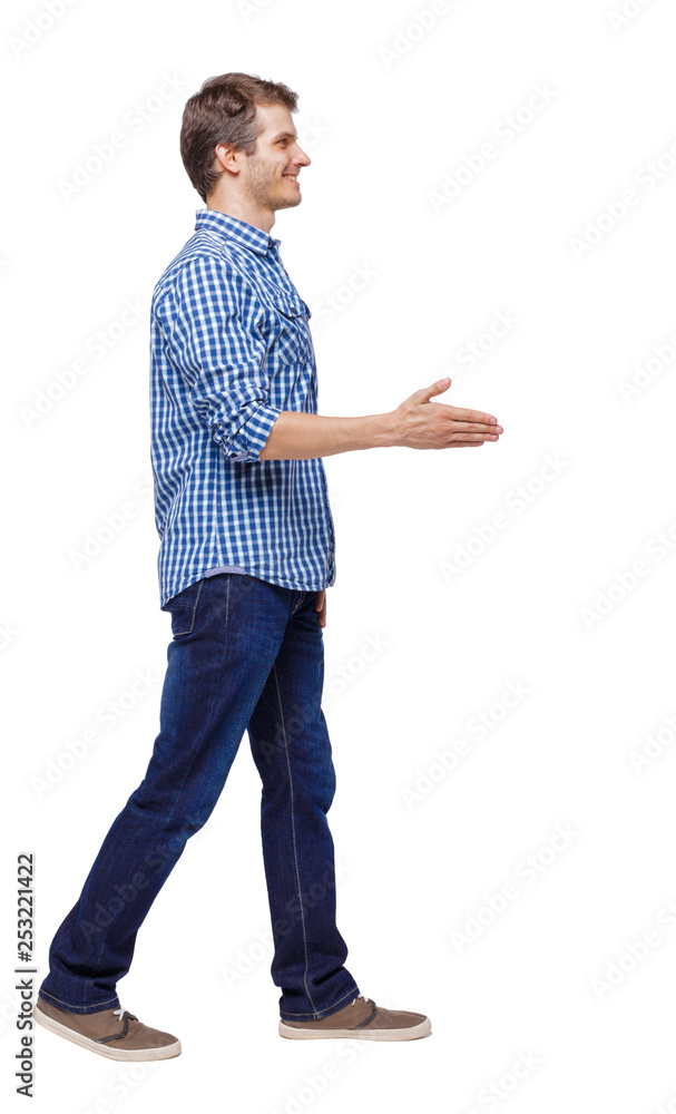 Side view of a walking businessman who stretches his hand for a handshake. Side view of a walking businessman who stretches his hand for a handshake.