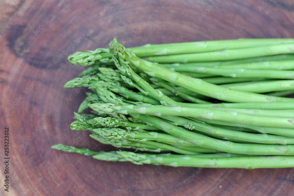 Raw asparagus. Fresh Asparagus on wooden background Raw asparagus. Fresh Asparagus on wooden background