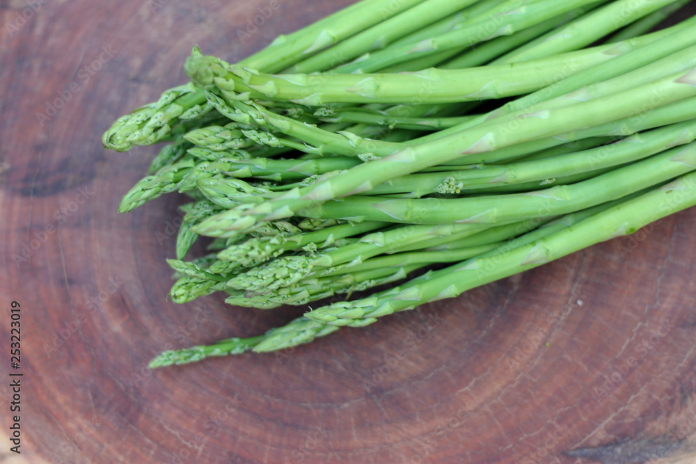 Raw asparagus. Fresh Asparagus on wooden background Raw asparagus. Fresh Asparagus on wooden background