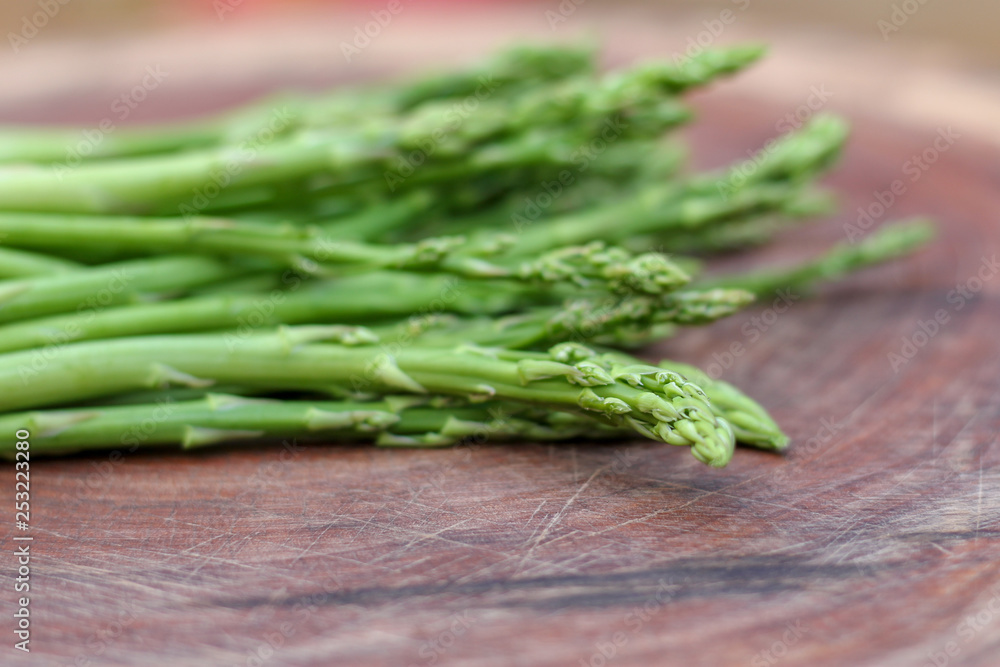 Raw asparagus. Fresh Asparagus on wooden background Raw asparagus. Fresh Asparagus on wooden background