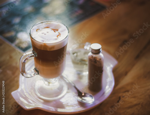 cup of coffee with whipped cream on wooden background