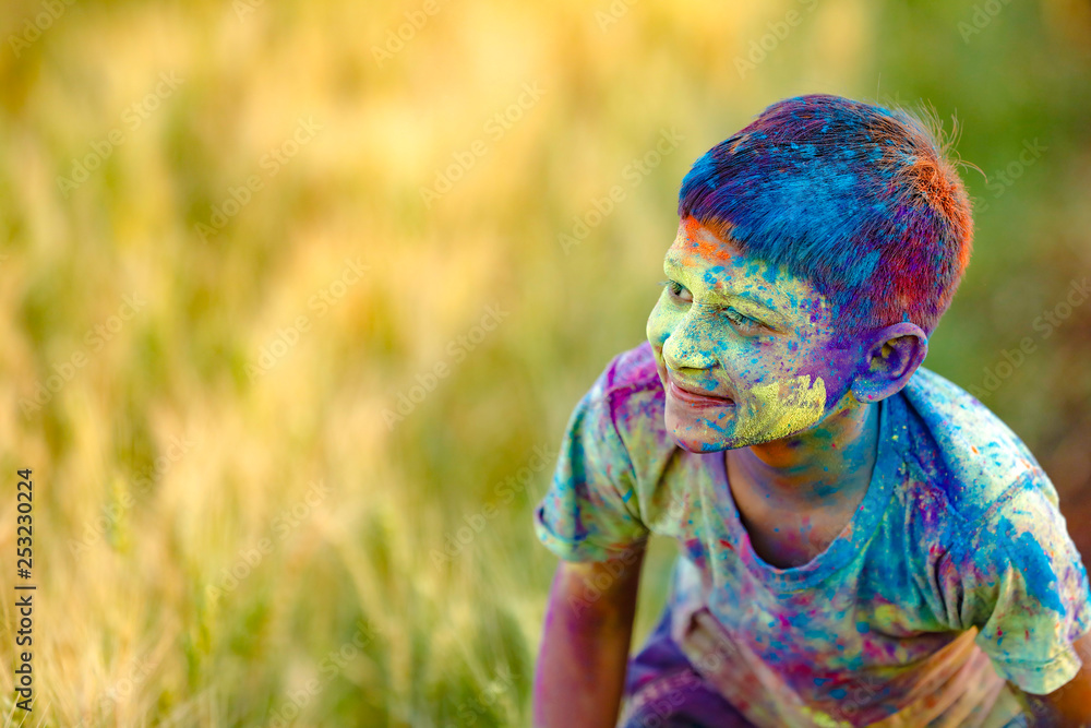 Indian child playing with the color in holi festival Indian child playing with the color in holi festival