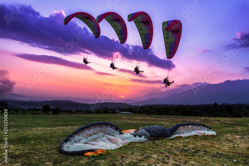 Paragliding is an aerial sport where you can let your body be free and feel that chill of the wind flying several thousands of meters high in the sky. Action shot of a para-glider landing