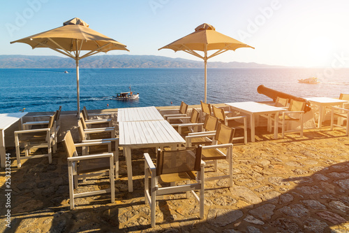 Cafe with umbrellas overlooking the sea. Hydra island  Greece.