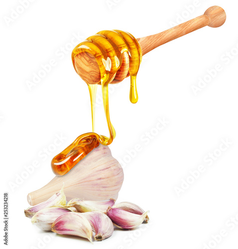honey dripping on garlic isolated on white