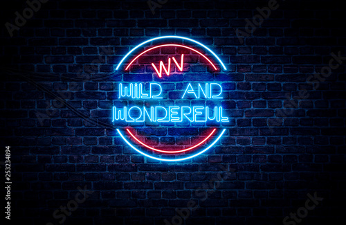 A blue and red neon sign on a brick wall that reads: WV WILD AND WONDERFUL . photo