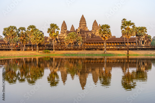 View of Angkor Wat temple on sunset in golden light with reflection in the pond © arkady_z