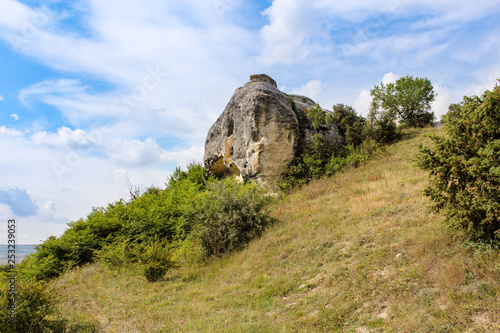 The rock on the green slope.
