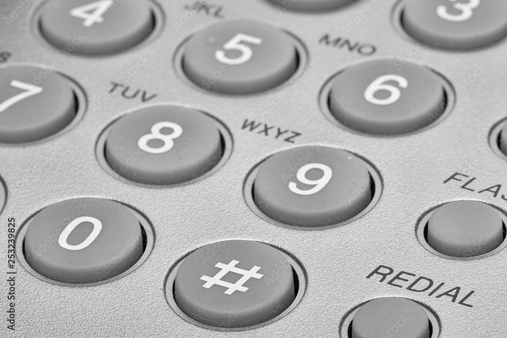 A close up of a Black office IP Phone on a desk A close up of a Black office IP Phone on a desk