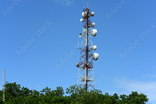 Telecommunication tower with cell phone antenna system.Telecommunication tower view from bellow.Telecom Worker Climbing Antenna Tower.