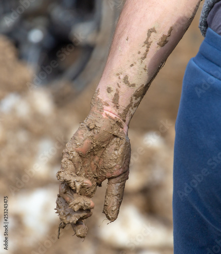 Dirt in clay on a man’s hand