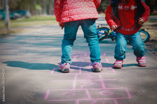 little girls play hopscotch on playground, kids outdoors