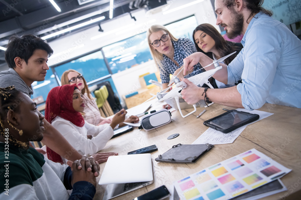 Obraz premium multiethnic business team learning about drone technology
