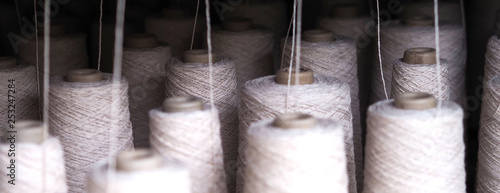 Row of textile threads industry .