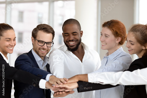 Diverse business people group put hands together in stack pile