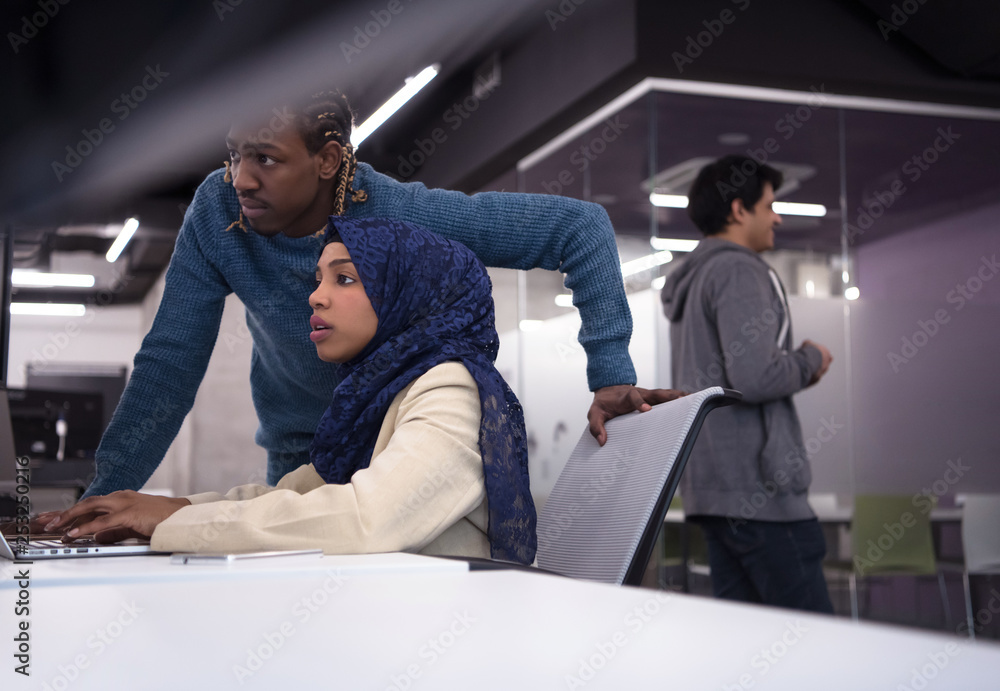 young black muslim female software developer at work