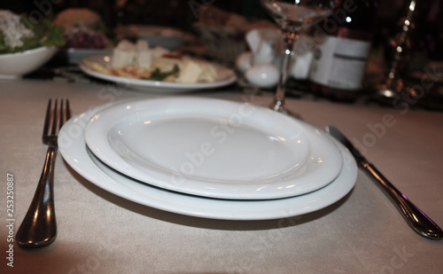 Empty plate, fork and knife on the table