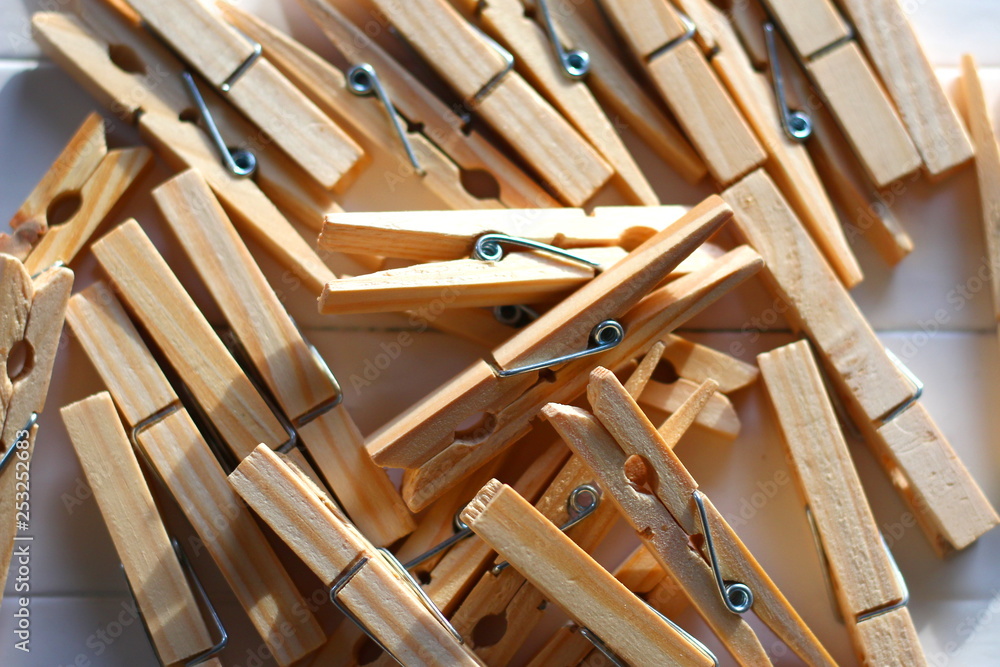 Some wooden clothes pegs made of spruce placed on a table 