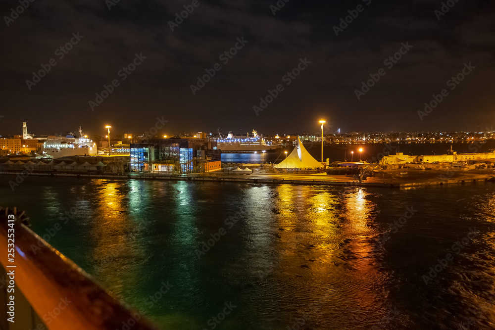 Night view of the Bari harbor with moored ferry, Italy