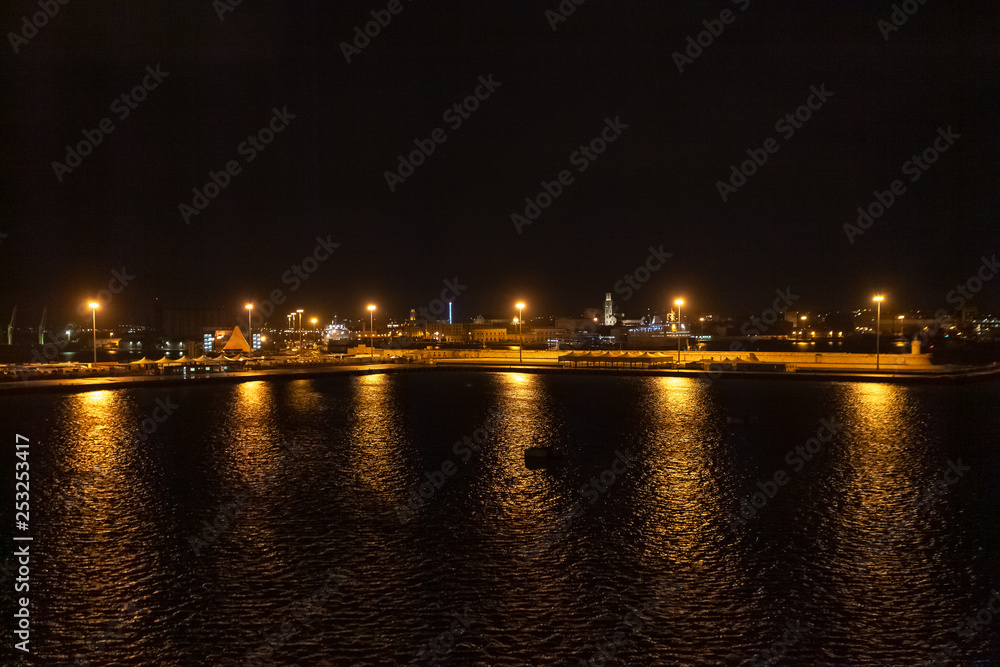 Night view of the port of Bari with the illuminated city in the background