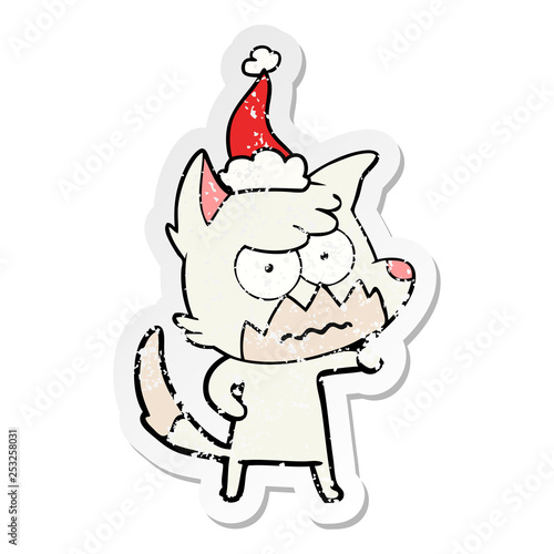 distressed sticker cartoon of a annoyed fox wearing santa hat