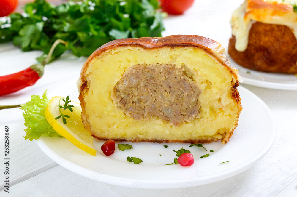 Potato balls with minced meat in deep fat, baked with mozzarella. Cut, close-up Potato balls with minced meat in deep fat, baked with mozzarella. Cut, close-up