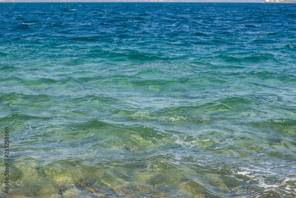 Obraz premium vivid blue colorful sea water surface with small waves in perspective foreshortening background