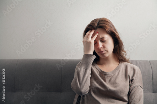 Young attractive woman in depression with a headache.