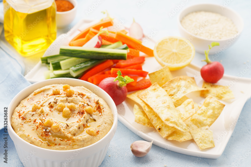 Hummus and variety of vegetable sticks and chips. Hummus and variety of vegetable sticks and chips.