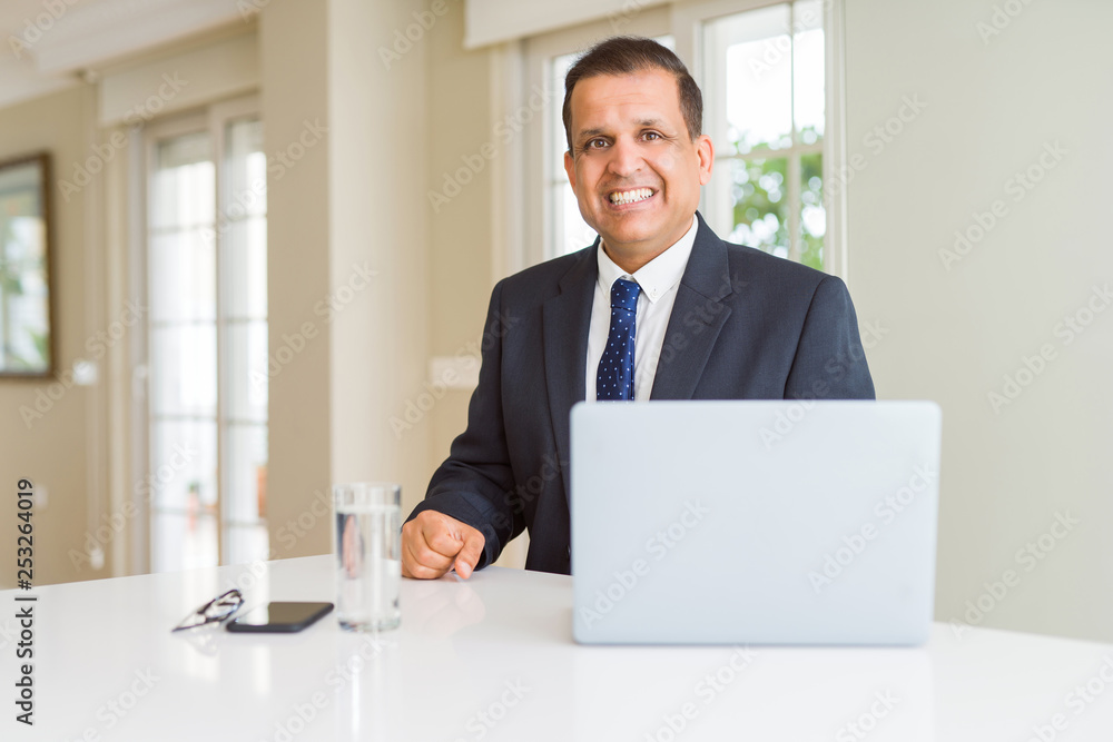 Middle age business man working with computer laptop with a happy and cool smile on face. Lucky person. Middle age business man working with computer laptop with a happy and cool smile on face. Lucky person.