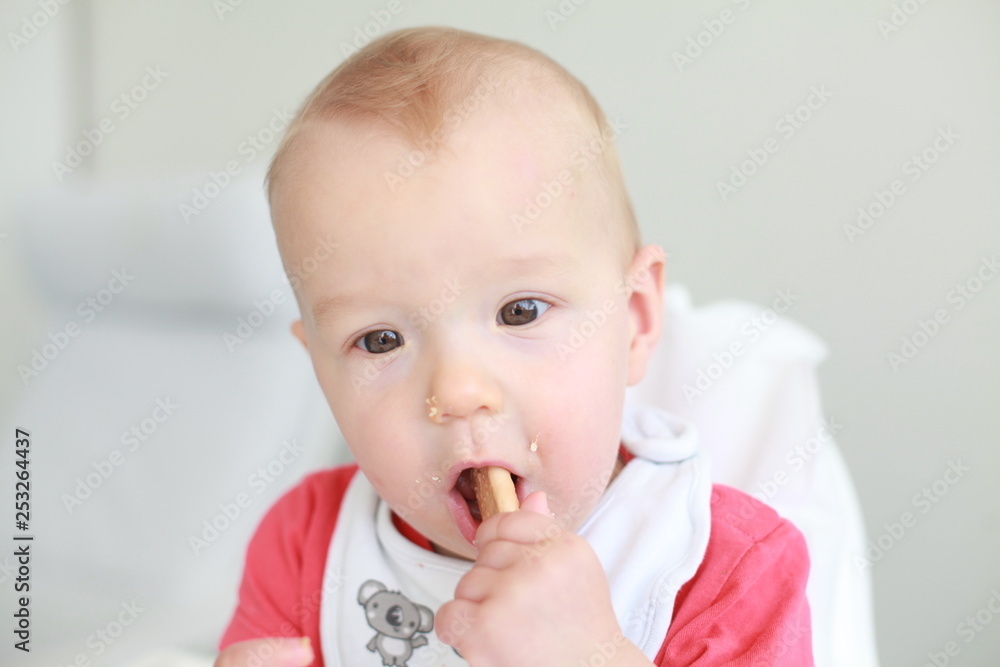 Cute little boy eating his first baby food Cute little boy eating his first baby food