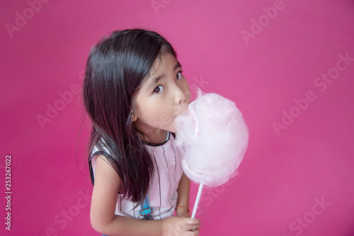 cute asian Thai girl eating sugar cotton