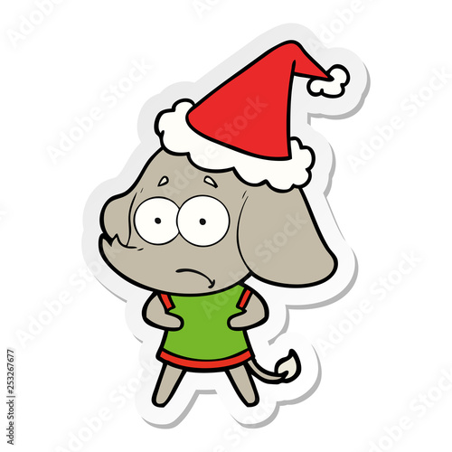 sticker cartoon of a unsure elephant wearing santa hat