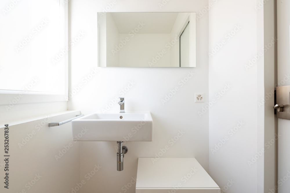 Front view with sink, mirror and window Front view with sink, mirror and window