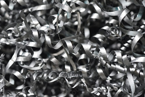 A lot of metal shavings close-up, after working on a milling machine or CNC machine. Texture metal shavings macro photo