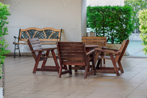 The background of a wooden chair, wooden table, a wall decoration or a sitting area in the house (coffee shop, condominium) to sit and relax during the day